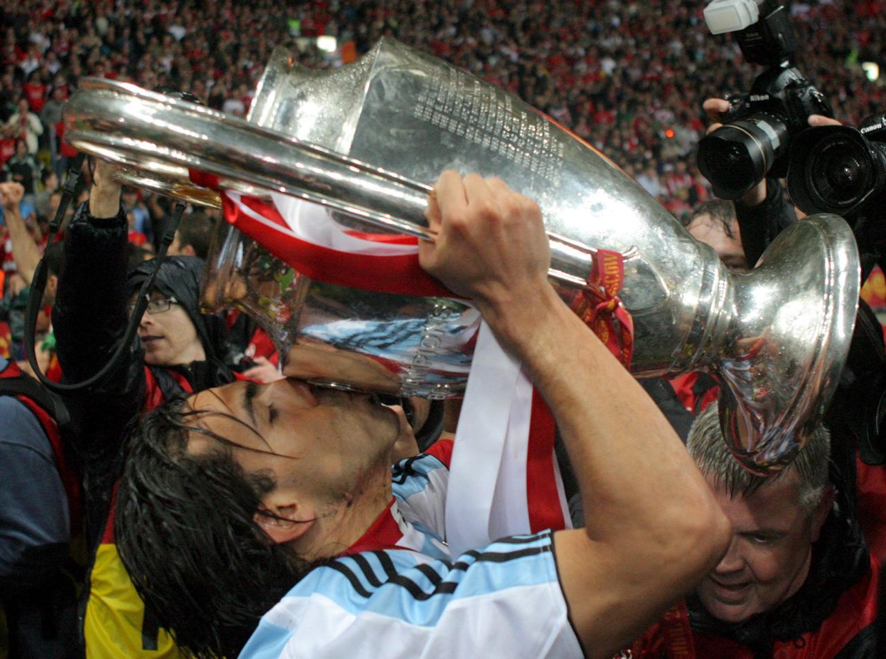  Tevez donned an Argentina shirt as he lifted the famous trophy in Moscow