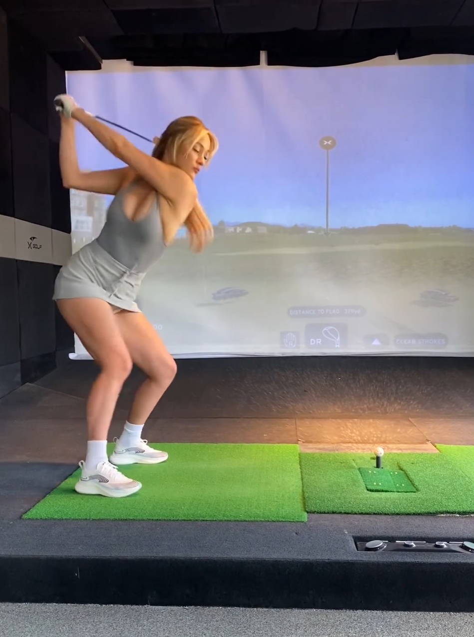 Accompany Paige Spiranac to the X-Golf Club and Observe Her Impressive Golf Stance 5